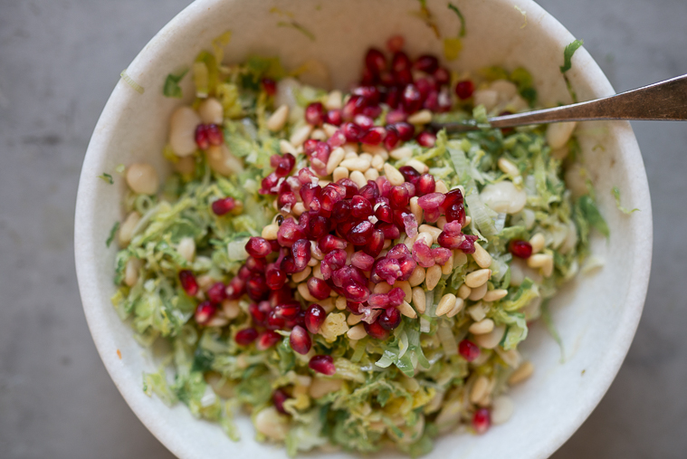 warm winter brussels sprout and butter bean salad with pomegranates pine nuts leeks