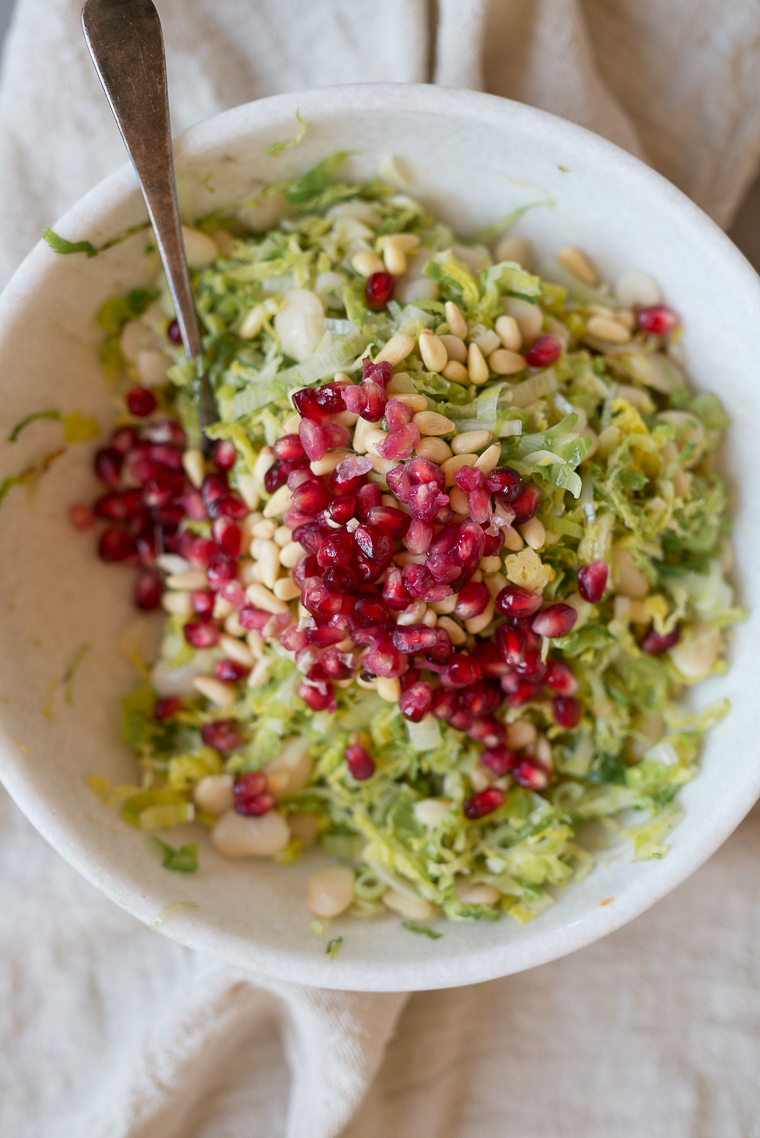 warm winter brussels sprout and butter bean salad pomegranate pine nuts leeks