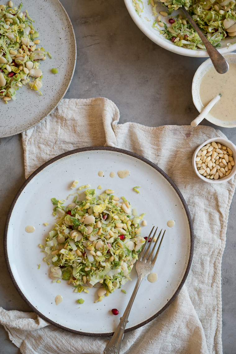 warm winter brussel sprout and butter bean salad pomegranates leeks pine nuts
